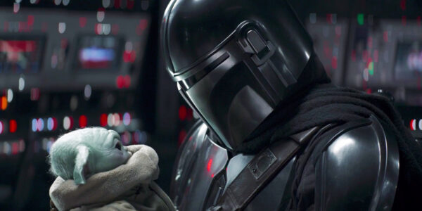 The Mandalorian holding Grogu close to his helmet in the Mandalorian Season 2 finale | Agents of Fandom