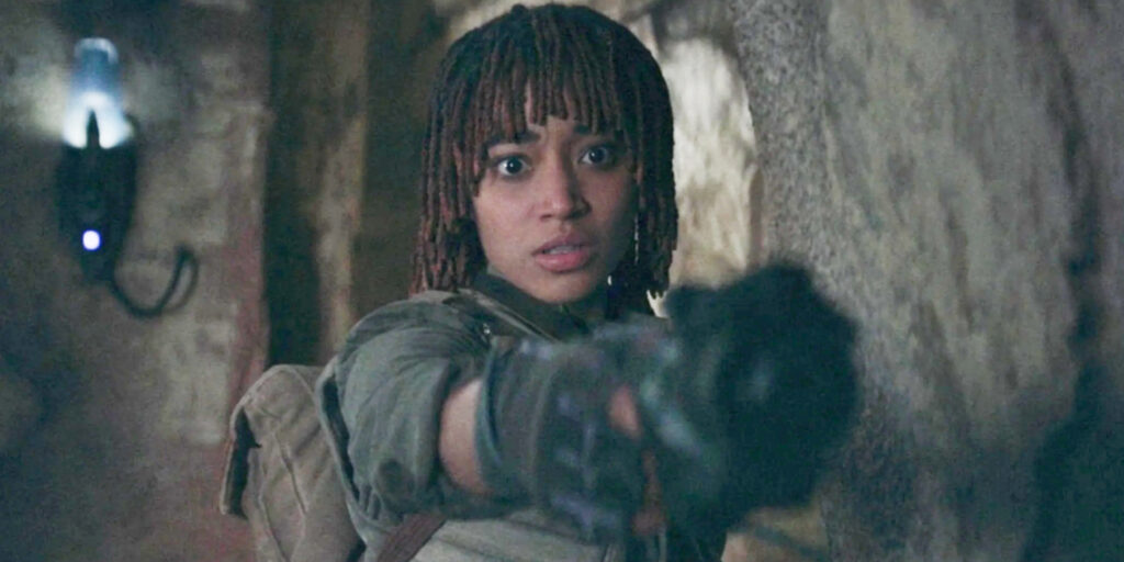 Amandla Stenberg as Osha in The Acolyte, pointing a stun gun towards the camera | Agents of Fandom