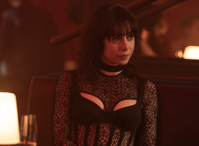 Cristin Milioti sitting with a smug smirk in a club in The Penguin Episode 3, "Bliss' | Agents of Fandom
