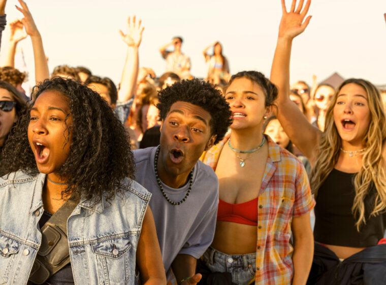 Pogues raising their hands and celebrating on the beach in Outer Banks Season 4 | Agents of Fandom