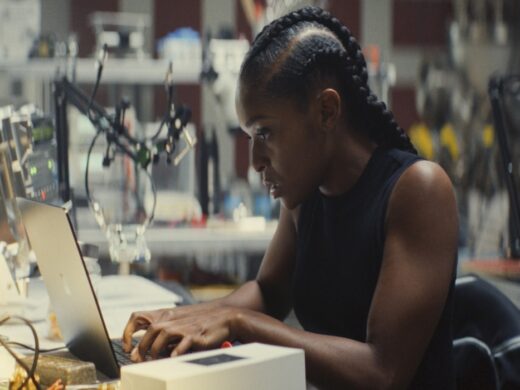 Dominique Thorne as Riri Williams in her suit destroying a truck in Ironheart