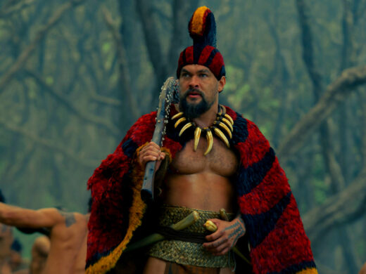 Jason Momoa as Ka'iana holding a club in Chief of War | Agents of Fandom