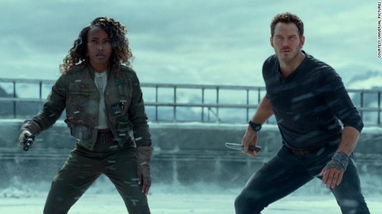 DeWanda Wise (left) and Chris Pratt (right) get ready to battle a dinosaur on a frozen lake.