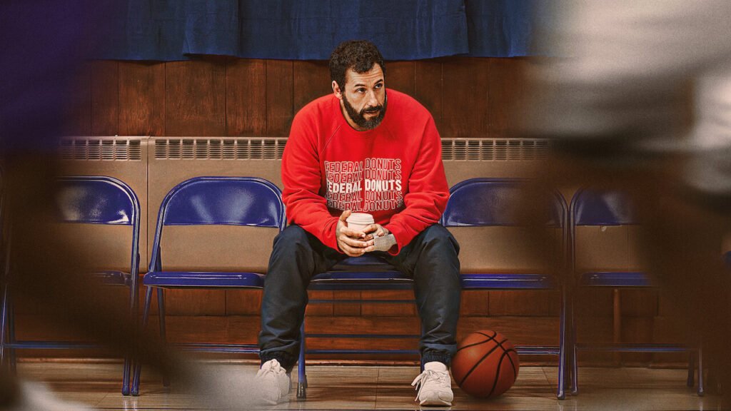 Adam Sandler stars as a washed up NBA scout betting his entire career on a street basketball player in Netflix | Agents of Fandom's 'Hustle'.