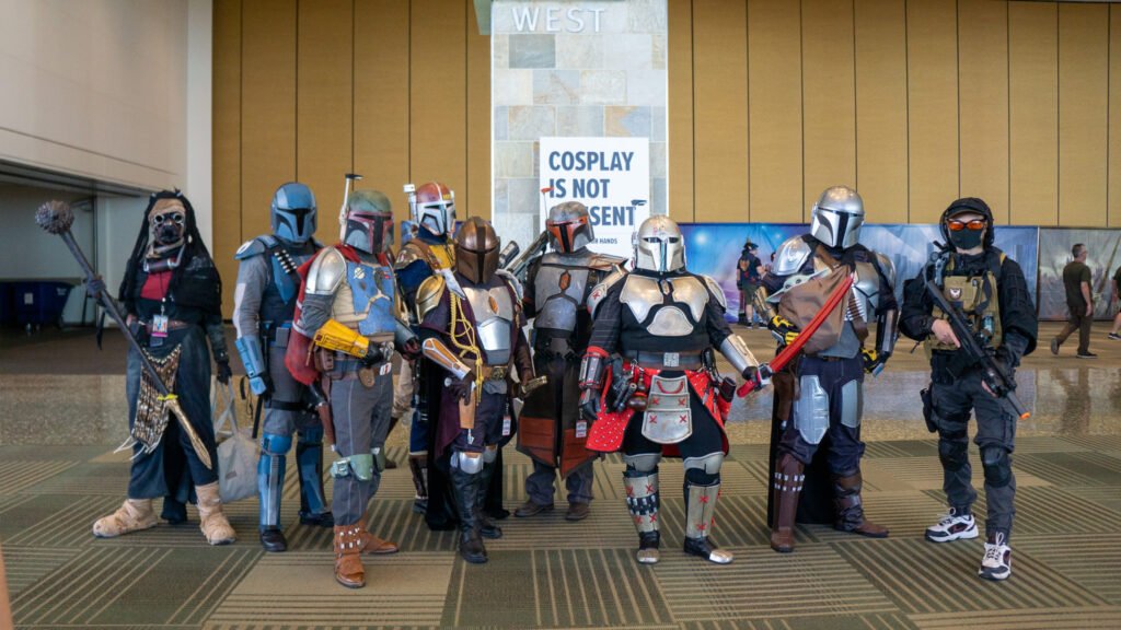 A group of Star Wars cosplayers standing in front of a sign that says "Cosplay is not consent."