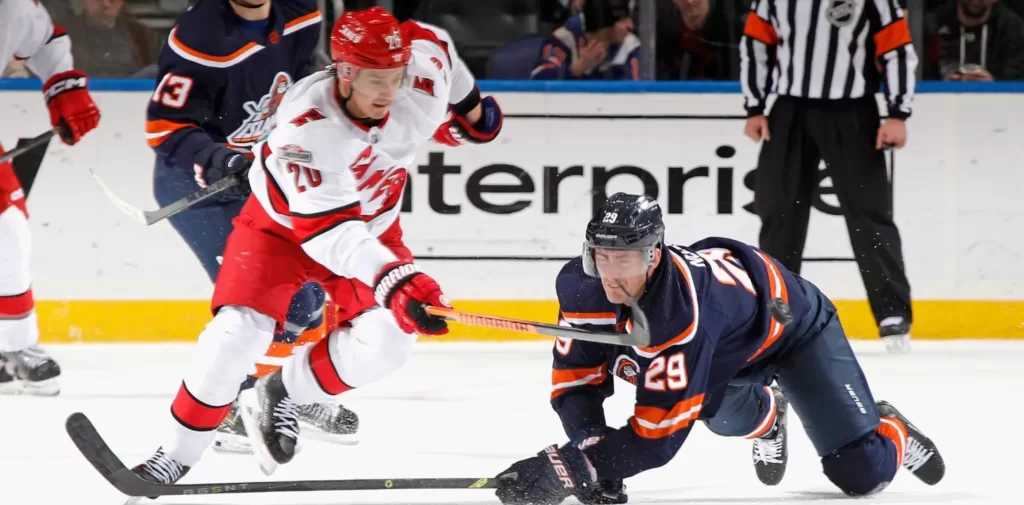 Carolina Hurricanes center Sebastian Aho (20) trying to secure the puck from New York Islanders center Brock Nelson (29) in a game between the two teams earlier this season | Agents of Fandom