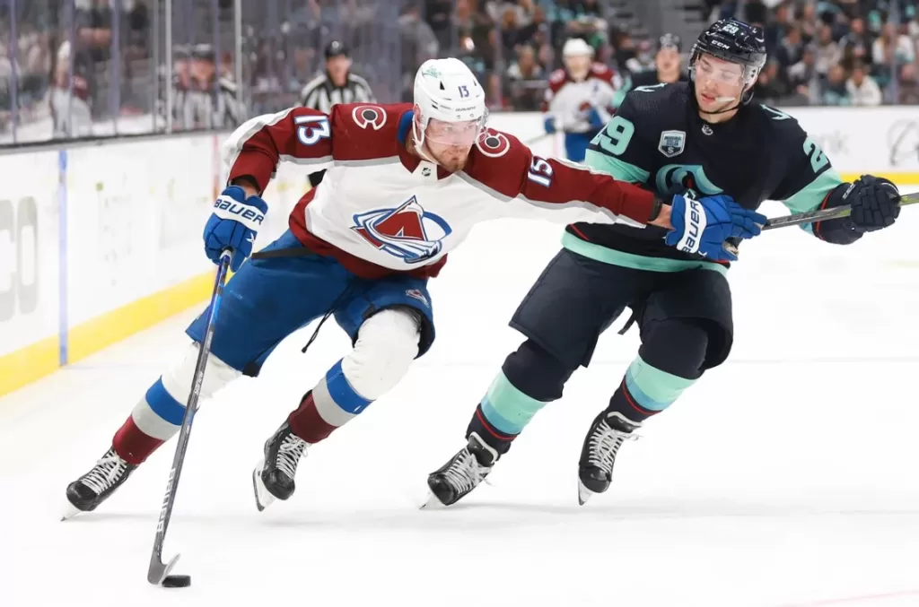 Colorado Avalanche forward Valeri Nichushkin (13) shielding Seattle Kraken defenseman Vince Dunn (29) from the puck during a game played between the two teams earlier this season | Agents of Fandom