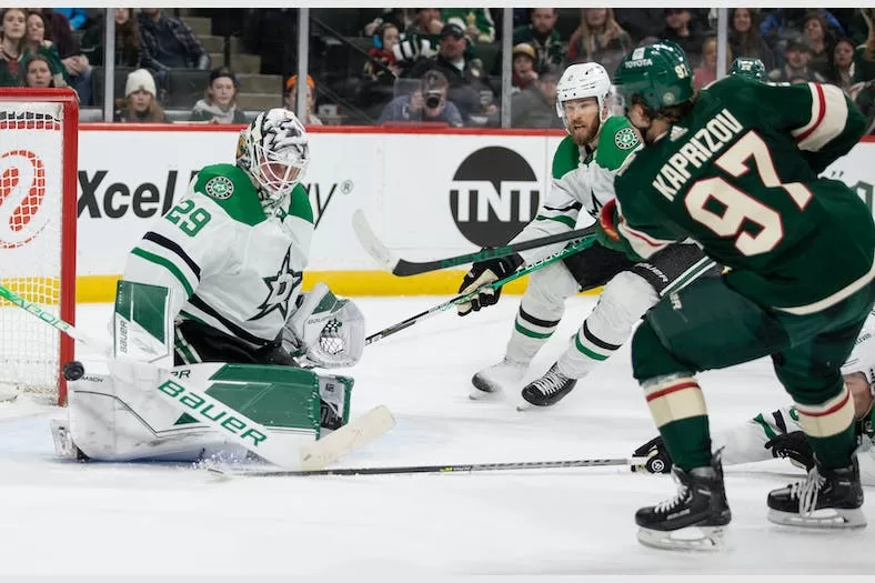 Minnesota Wild forward Kirill Kaprizov (97) scores a goal on Dallas Stars goaltender Jake Oettinger (29) in an NHL game that took place earlier this season | Agents of Fandom