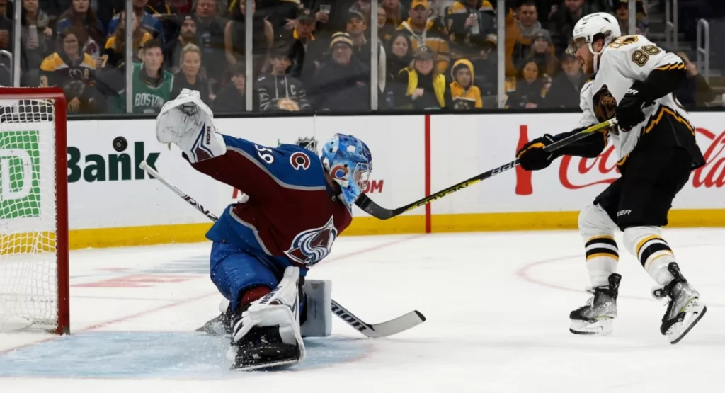 Boston Bruins winger David Pastrnak (88) scores a goal on Colorado Avalanche goaltender Pavel Francouz (39) during a December 3rd, 2022 game at TD Garden | Agents of Fandom