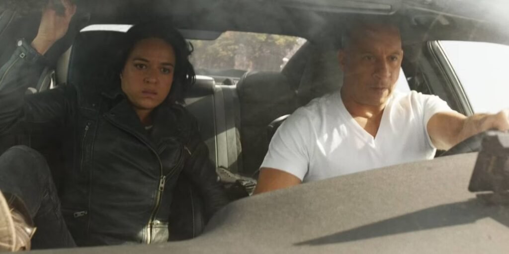 Letty (Michelle Rodriguez) and Dom (Vin Diesel) pictured inside their vehicle during F9: The Fast Saga | Agents of Fandom