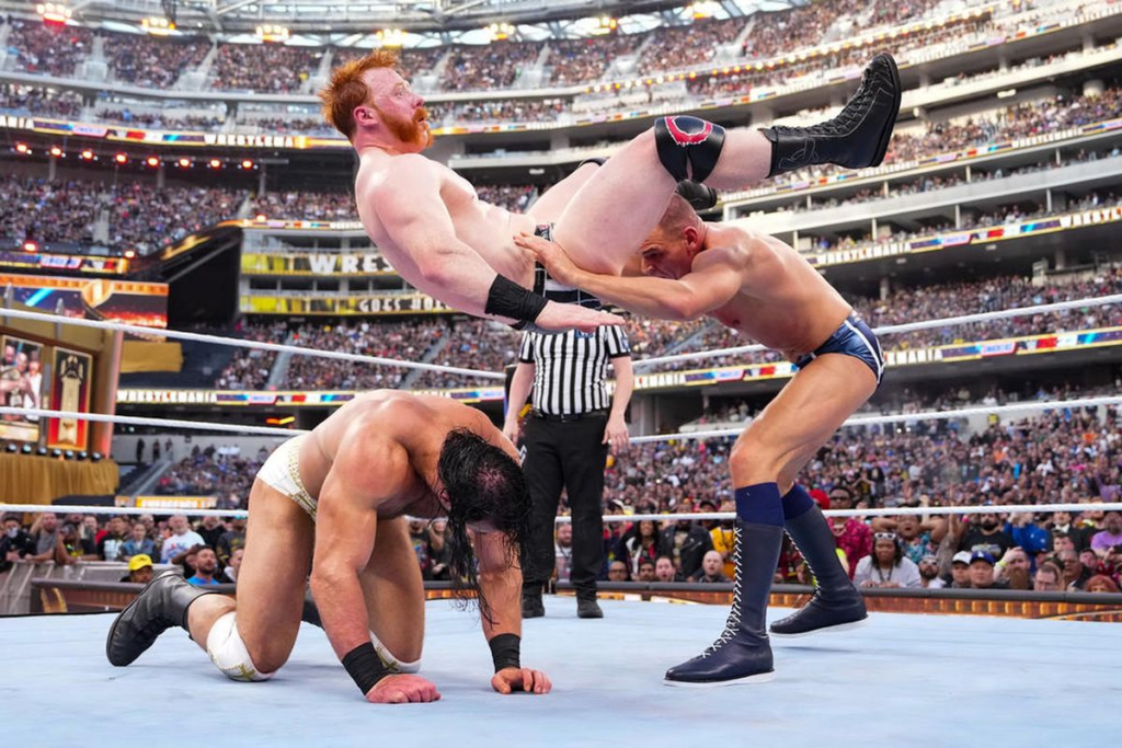 Gunther Power bombs Sheamus onto Drew McIntyre to retain his championship at Wrestlemania. | Agents of Fandom