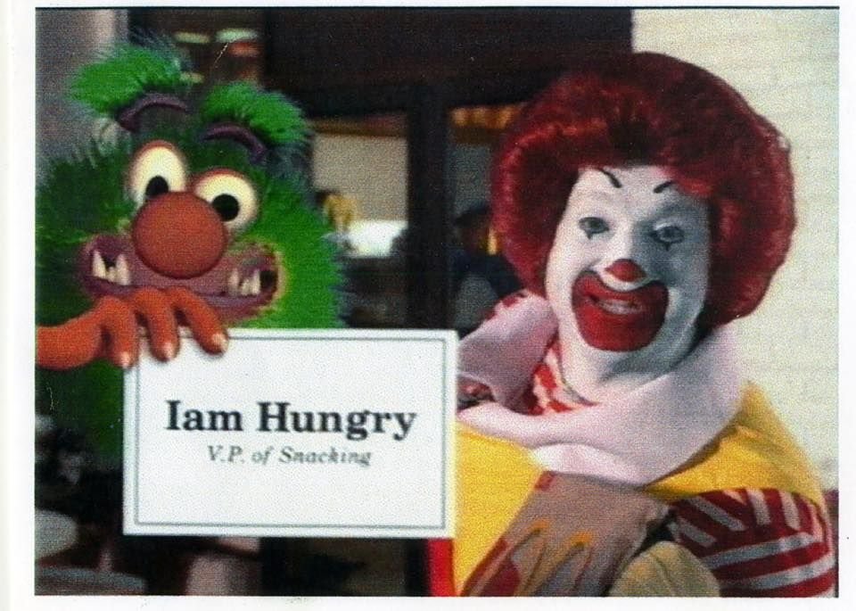 Iam Hungry, a computer generated character, poses with his business card next to Ronald McDonald | Agents of Fandom