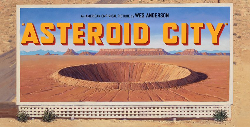 A giant billboard that reads "Asteroid City" with a giant hole in the middle surrounded by desert | Asteroid City Review | Agents of Fandom 