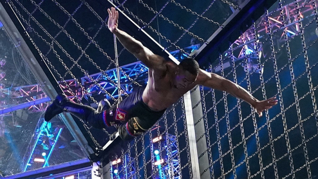 “From the Heavens!” Montez Ford flys off the top of the Elimination Chamber Structure to take out the field. | Agents of Fandom