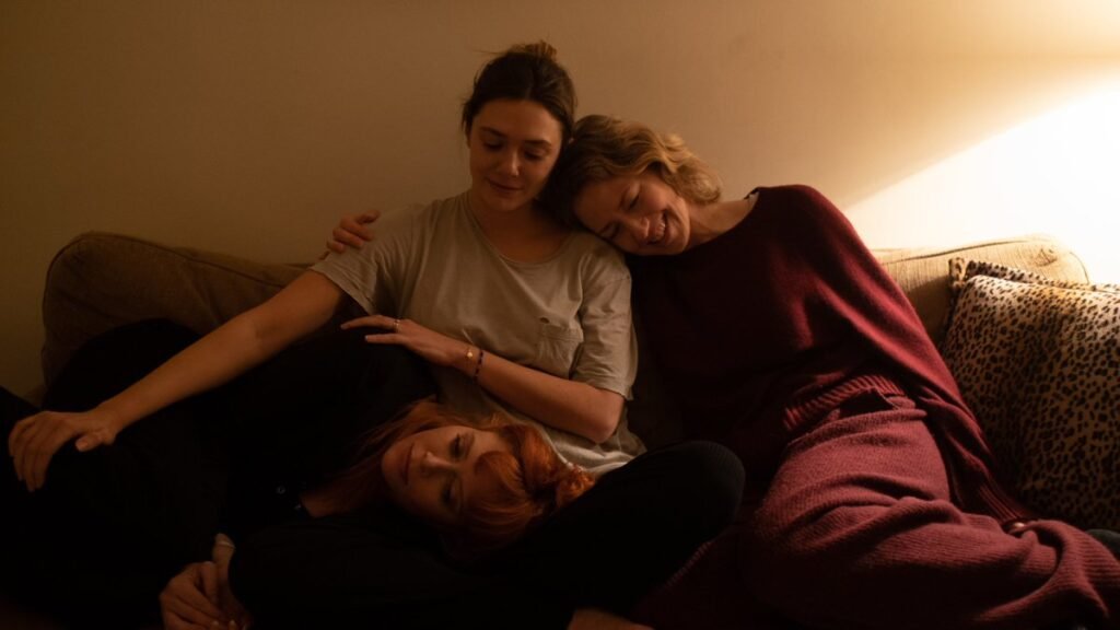 A still from His Three Daughter with Elizabeth Olsen is in the middle, Natasha Lyonne resting her head on Olsen's lap and Carrie Coon resting her head on Olsen's shoulder | TIFF 2023 | Agents of Fandom