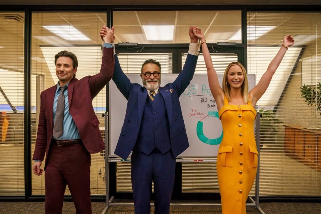 A film still from Pain Hustlers with Andy Garcia holding the hands of Chris Evans and Emily Blunt up in the air | TIFF 2023 | Agents of Fandom