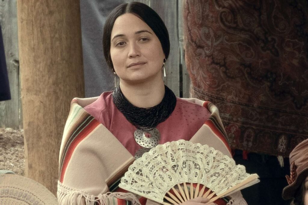 Lily Gladstone holding a fan in Killers of the Flower Mon | Agents of Fandom