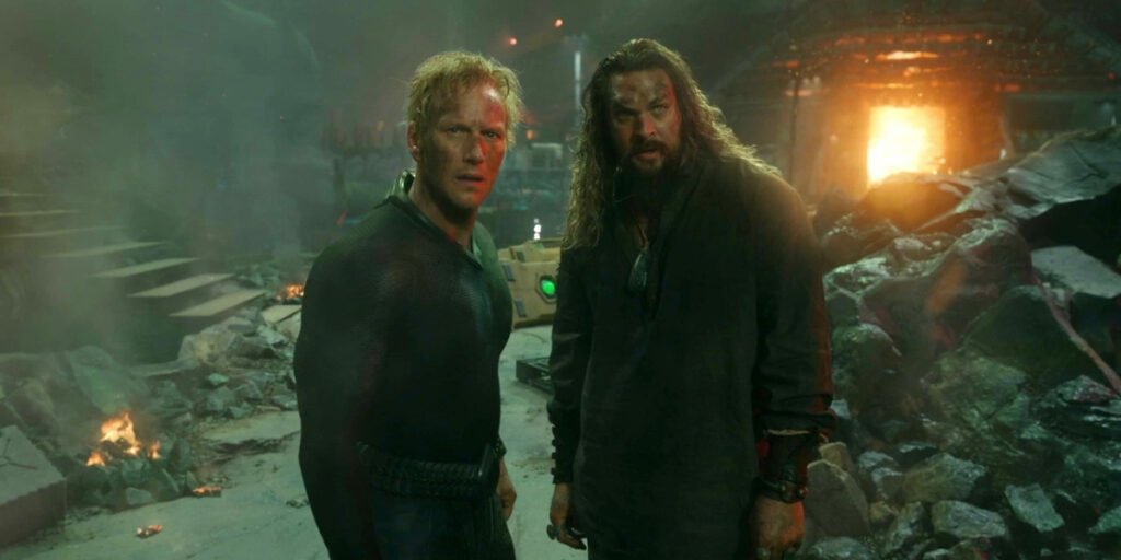 Patrick Wilson as Orm and Jason Momoa as Arthur Curry standing in rubble in Aquaman and the Lost Kingdom | Agents of Fandom