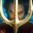 Jason Mamoa as Aquaman holding his trident underwater in Aquaman and The Lost Kingdom | Aquaman and The Lost Kingdom review | Agents of Fandom
