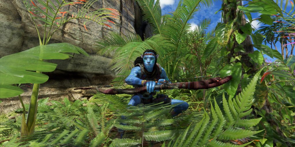 The main character standing in the foliage holding his bow in Avatar: Frontiers of Pandora | Agents of Fandom