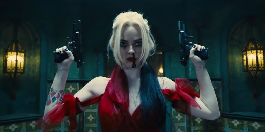 Margot Robbie holding guns as Harley Quinn in The Suicide Squad | Agents of Fandom