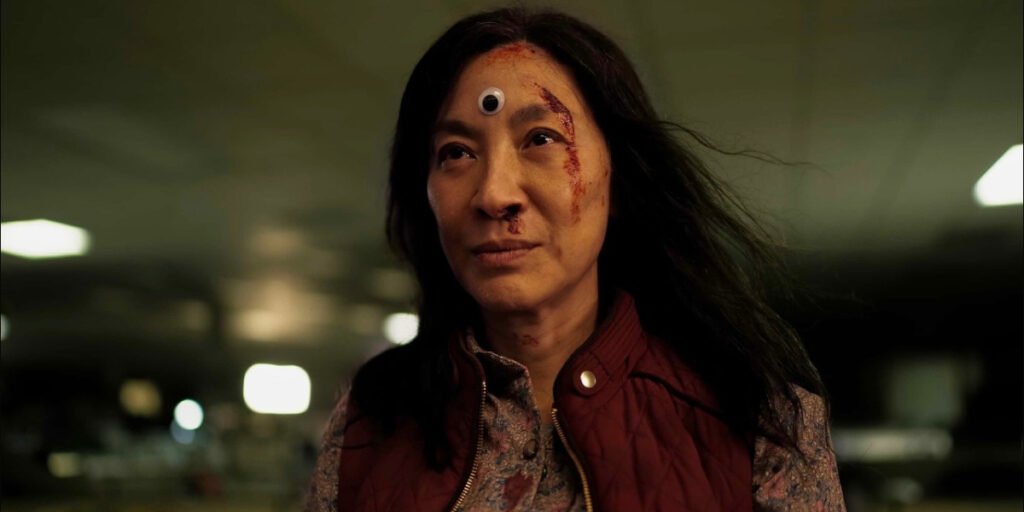 Michelle Yeoh as Evelyn Wang with a googly eye on her forehead in Everything Everywhere all at Once | Coming to Netflix February 2024 | Agents of Fandom