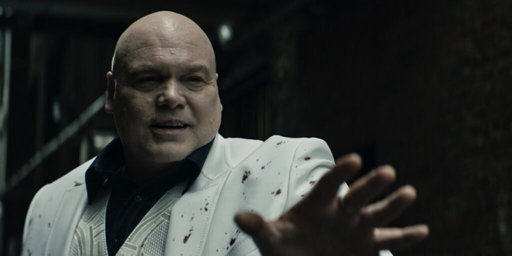 Vincent D'Onofrio as Kingpin wearing a white suit splattered in blood holding out his left hand in Echo | Agents of Fandom