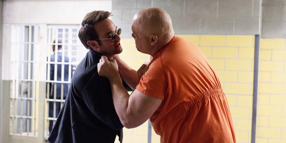 Vincent D'Onofrio as Wilson Fisk chocking Charlie Cox as Matt Murdock in a prison cell in Daredevil | Agents of Fandom