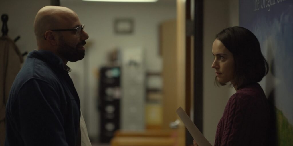 Robert (Dave Merheje, left) and Fran (Daisy Ridley, right) share a personal moment in the hallway of their office in Sometimes I think About Dying I Agents of Fanom