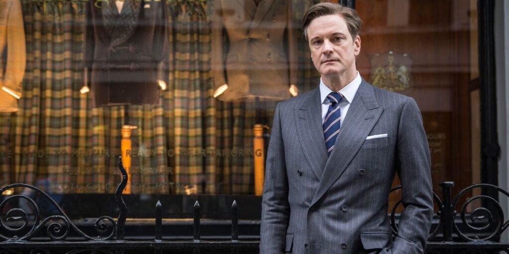 Colin Firth as Harry Hart in Kingsman: The Secret Service stood outside the Kingsman tailor shop | Agents of Fandom