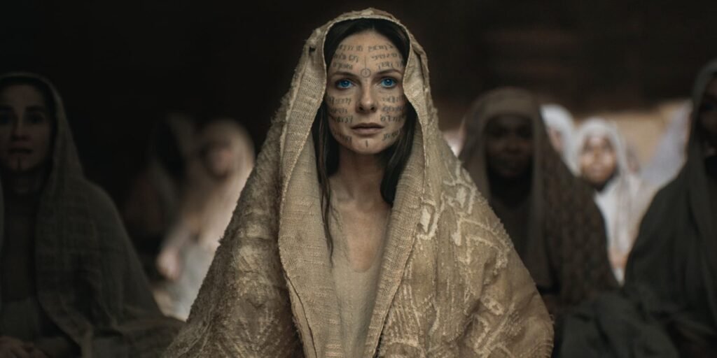 Rebecca Ferguson as Lady Jessica covered in a robe amongst other ladies in Dune: Part Two | Agents of Fandom
