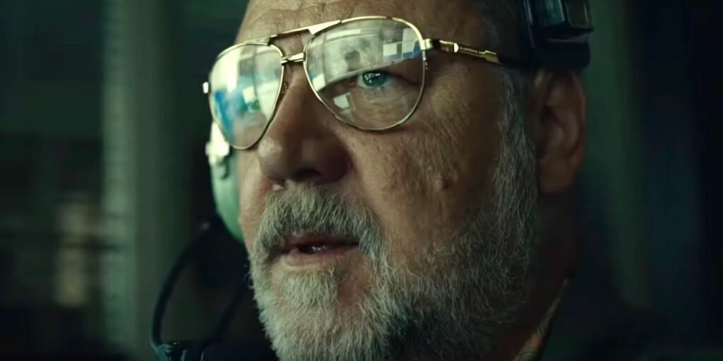 Close-up of Rusell Crowe as a drone pilot, his computer reflected in his glasses in Land of Bad | Agents of Fandom