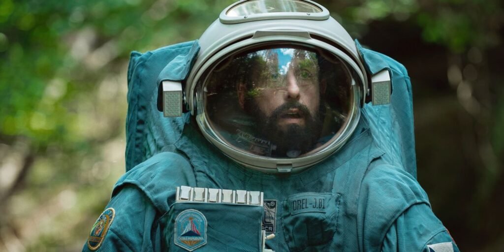Adam Sandler as Jakub Prochazka in his blue space suit in his imagination in Spaceman | Agents of Fandom