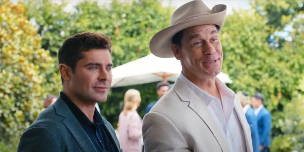 Zac Efron (left) and John Cena (right) smiling outside in a scene from 'Ricky Stanicky' | Agents of Fandom