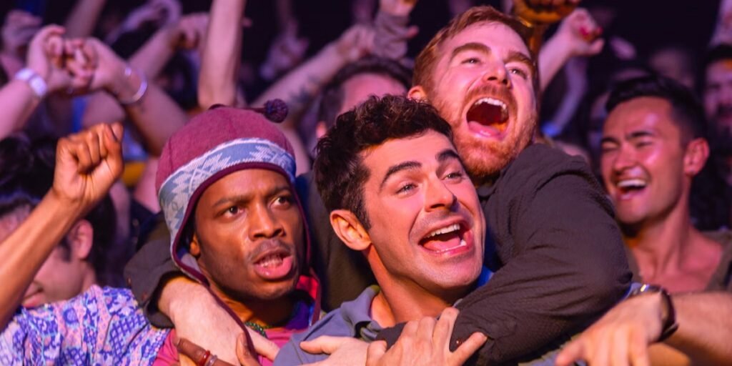 Jermaine Fowler (left), Zac Efron (middle) and Andrew Santino (right) attending a concert in Atlantic City during a scene from 'Ricky Stanicky' | Agents of Fandom