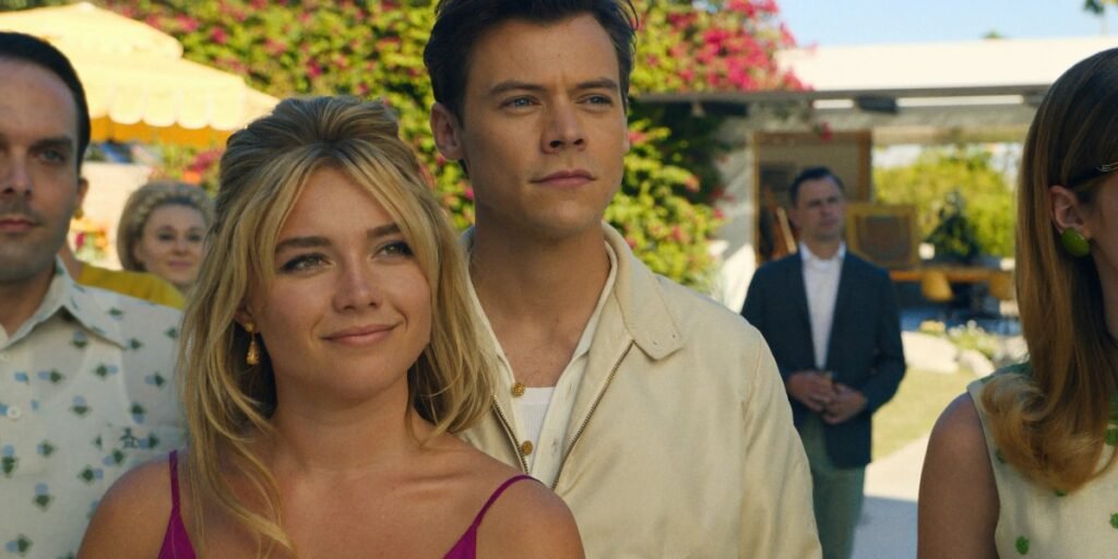 A blonde young woman (Florence Pugh) stands outside with a brunette young man (Harry Styles) surrounded by greenery | Agents of Fandom