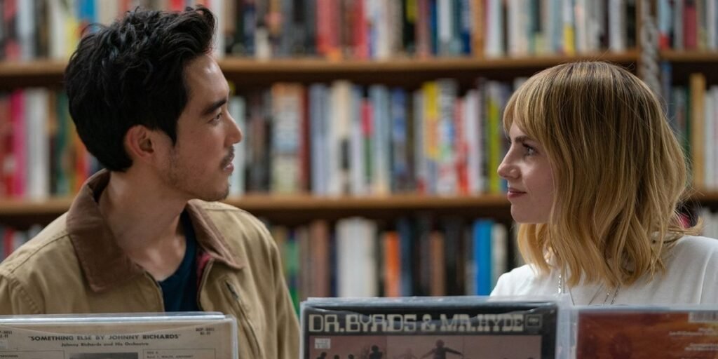 Harriet (Lucy Boynton, right) begins to strike up a romantic relationship with David (Justin H. Min, left) in a record shop in The Greatest Hits I Agents of Fandom