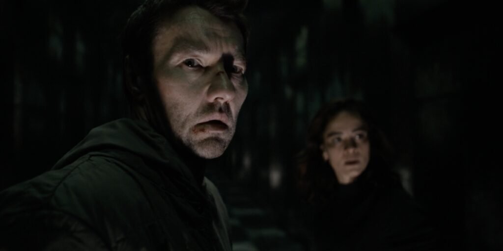 Joel Edgerton as Jason Dessen and Alice Braga as Amanda Lucas standing in a corridor | Agents of Fandom