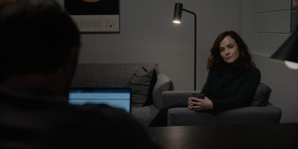 Alice Braga as Amanda Lucas sitting in a chair opposite Joel Edgerton's Jason Dessen in Dark Matter Episode 3 | Agents of Fandom