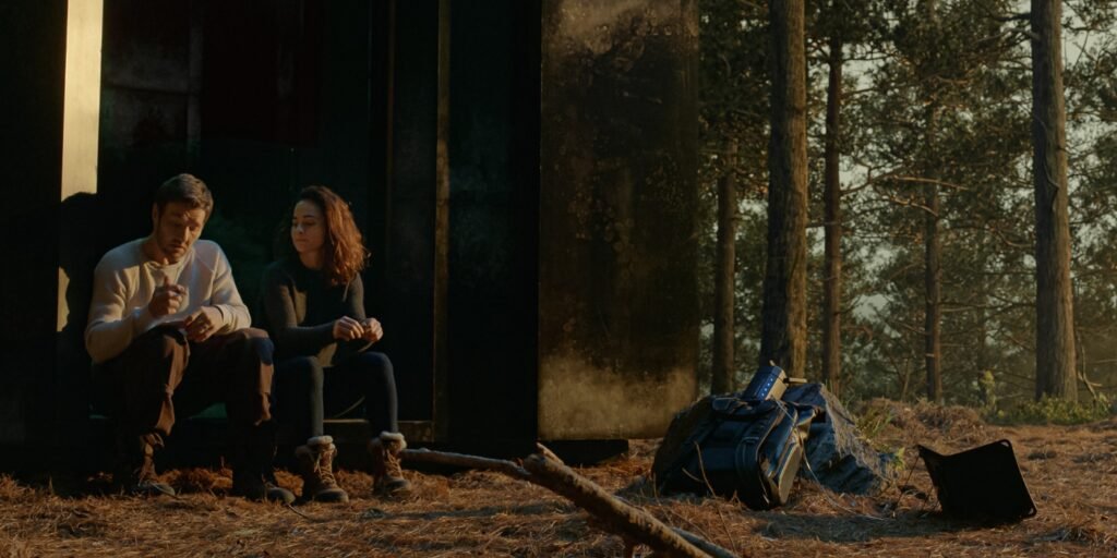Jason and Amanda sitting outside the box in a forest planning their next move in Dark Matter Episode 6 | Agents of Fandom