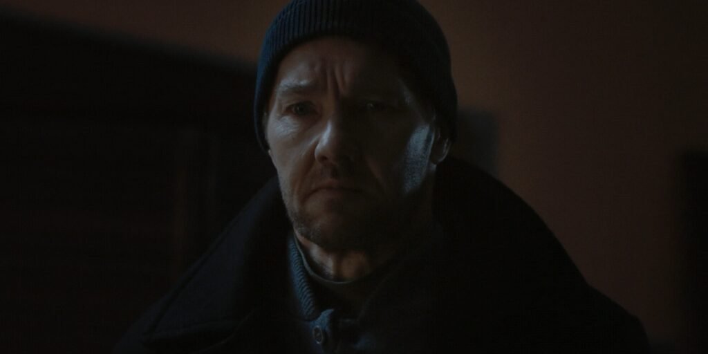 Joel Edgerton as Jason Dessen standing in a beanie and trench coat in Dark Matter Episode 7 | Agents of Fandom