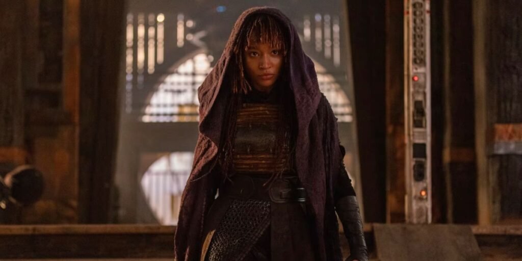 Amandla Stenberg as Mae standing in her purple robes in The Acolyte | Agents of Fandom