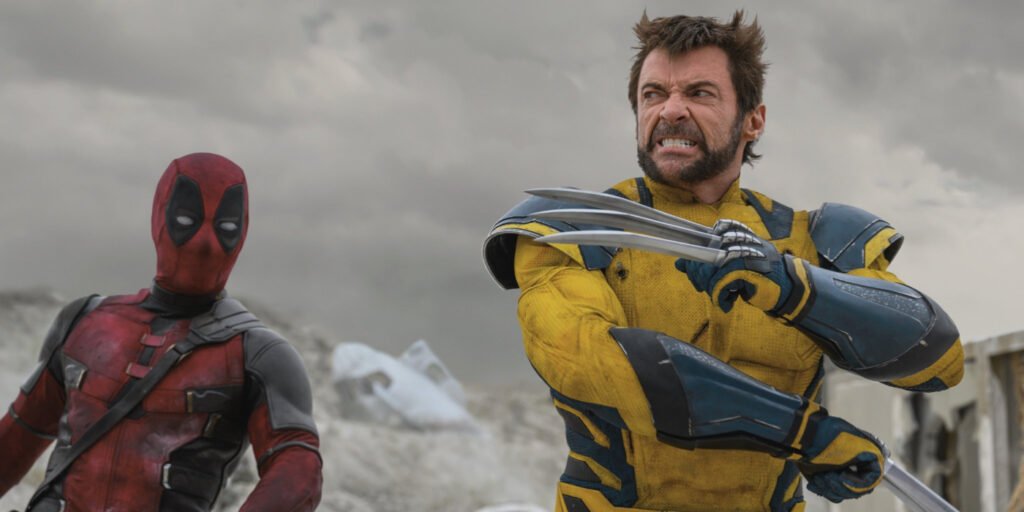 Wolverine looking angry with his claws out as Deadpool is off to the side in Deadpool & Wolverine | Agents of Fandom