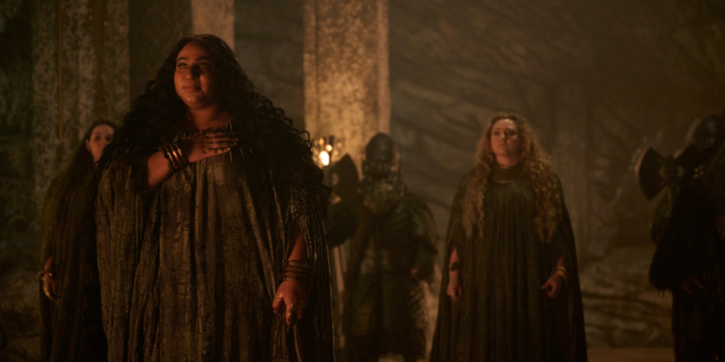 Sophia Nomvete Princess Disa stands in the stone halls of the dwarves preparing to sing her stone song with her fellow Singers behind her | Agents of Fandom