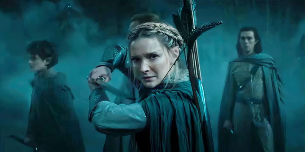 Morfydd Clark as Galadriel with her sword drawn and prepared for battle as the other Elves gather behind her | Agents of Fandom.