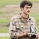 Jacob Elordi holding a film camera in an open field in Paul Schrader's Oh, Canada | Agents of Fandom