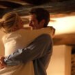 Almut (Florence Pugh) and Tobias (Andrew Garfield) smiling at each other as they embrace in We Live in Time | Agents of Fandom