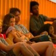 The Outer Banks cast sits against an orange shipping container | Agents of Fandom