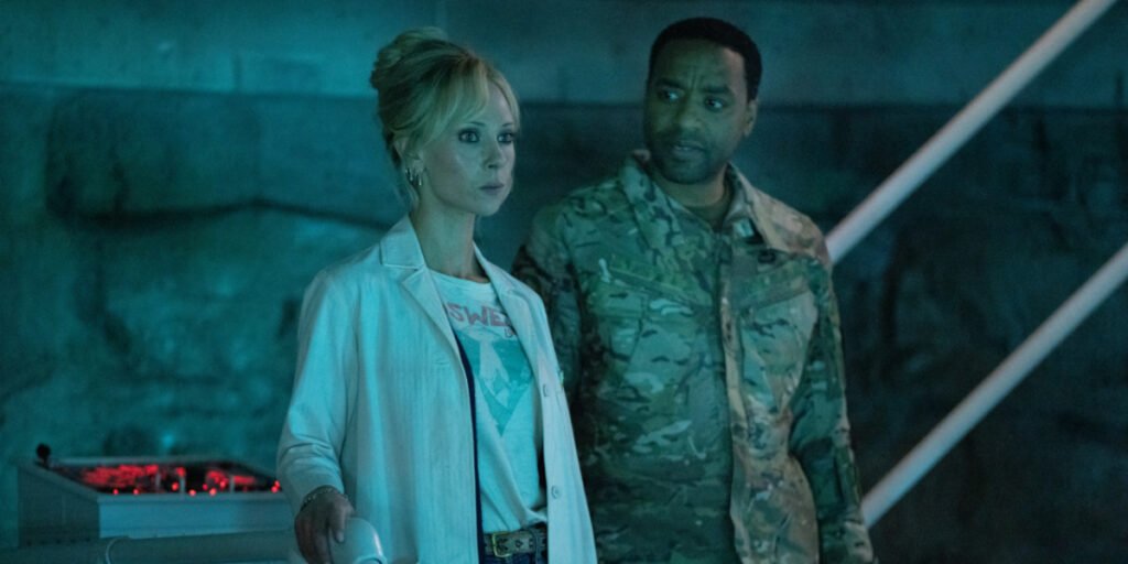 Rex Strickland (Chiwetel Ejiofor) looks at Teddy Payne (Juno Temple) as she's focused on something else in her lab in Venom: The Last Dance | Agents of Fandom