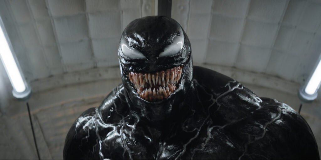 Venom (Tom Hardy) gives a big smile as he's about to face some foes in Venom: The Last Dance | Agents of Fandom